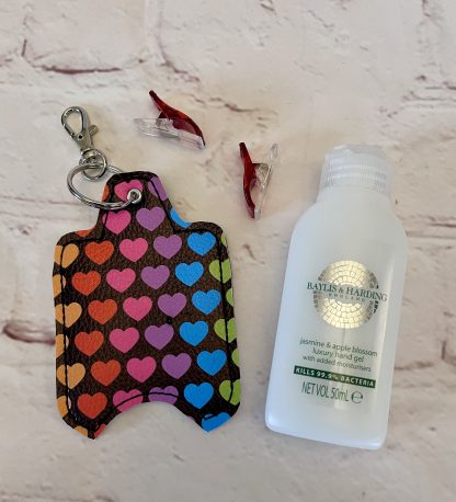 Picture of rainbow hearts hand sanitiser case made from vegan leatherette